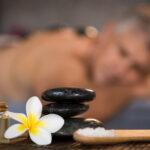 Male spa setting with black hot stones